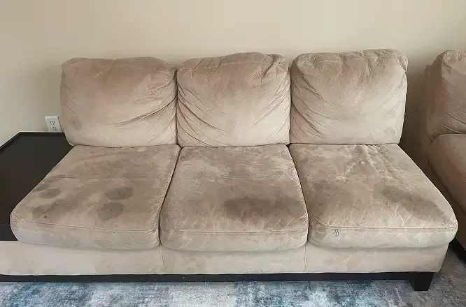 Three seater microsuede sofa with heavy dirt and body oil staining before cleaning in Adelaide